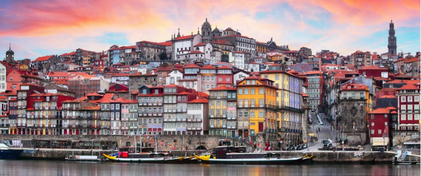 Colorful houses along the Ribeira district in Porto at night.